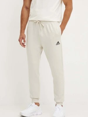 adidas spodnie dresowe Essentials kolor beżowy gładkie JH1039