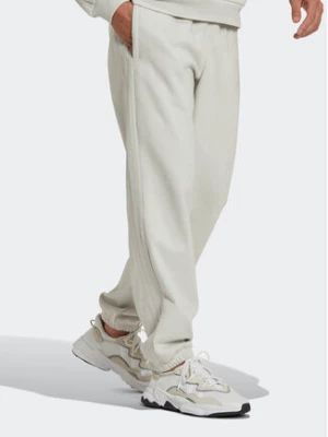 adidas Spodnie dresowe Reveal Essentials HK2728 Beżowy Regular Fit