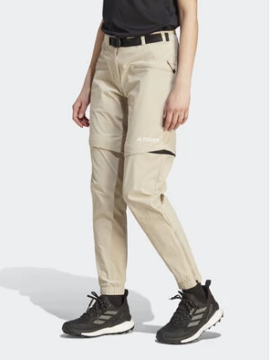 adidas Spodnie dresowe Terrex Utilitas Hiking Zip-Off Tracksuit Bottoms HZ9046 Beżowy Regular Fit