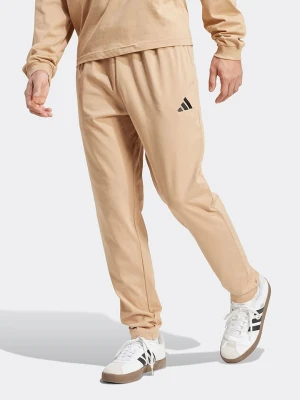 adidas Spodnie dresowe w kolorze beżowym rozmiar: XL