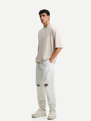 Bershka Jeansy Jogger Z Przetarciami Mężczyzna Biały