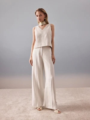 Beżowe spodnie z wysokim stanem z metaliczną nicią TARANKO