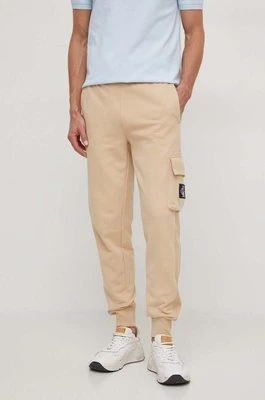 Calvin Klein Jeans spodnie dresowe bawełniane kolor beżowy gładkie
