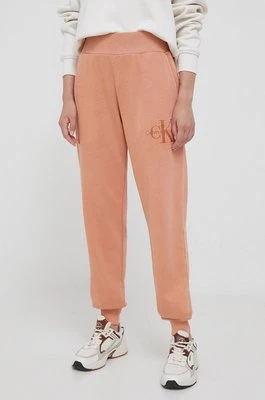 Calvin Klein Jeans spodnie dresowe bawełniane kolor pomarańczowy gładkie