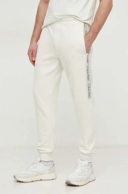 Calvin Klein spodnie dresowe kolor beżowy z aplikacją