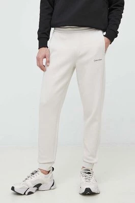 Calvin Klein spodnie dresowe męskie kolor beżowy gładkie