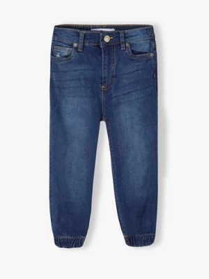 Ciemne spodnie jeansowe typu joggery dziewczęce Minoti