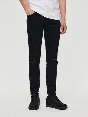 Czarne jeansy slim fit z przetarciami House