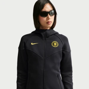 Damska bluza do piłki nożnej z kapturem i zamkiem na całej długości Nike Chelsea F.C. Tech Fleece Windrunner - Niebieski