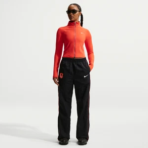 Damskie spodnie piłkarskie z wysokim stanem i luźnymi nogawkami Nike Chelsea F.C. Windrunner - Niebieski