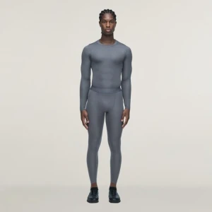 Długie legginsy treningowe adidas x entire studios Techfit Granite