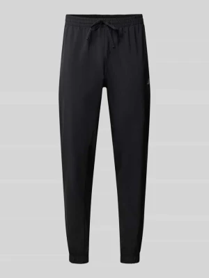 Dresowe spodnie o kroju straight fit model 'ESSENTIALS' New Balance Czarny