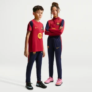 Dzianinowe spodnie piłkarskie dla dużych dzieci Nike Dri-FIT FC Barcelona Strike - Niebieski