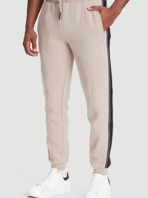 GUESS Beżowe spodnie męskie z lampasami Mickey, Rozmiar S