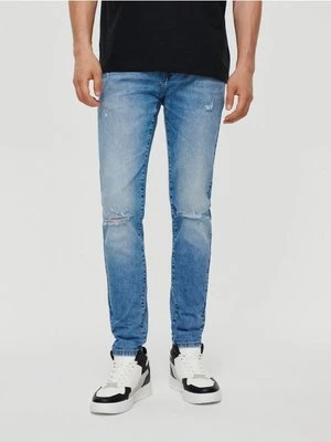 Jansnoniebieskie jeansy slim fit z przetarciami House