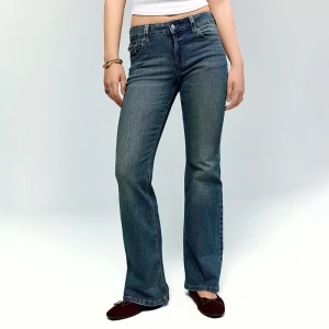 Jasnoniebieskie jeansy bootcut z niskim stanem i klapkami na kieszeniach House indigo jeans