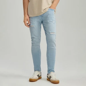 Jasnoniebieskie jeansy carrot fit z efektem sprania i przetarciami House