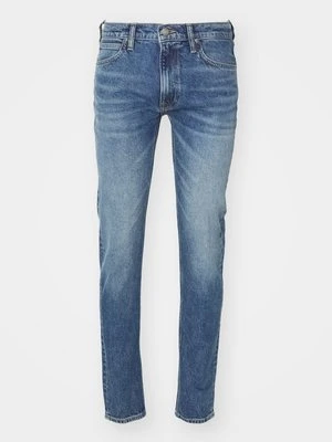 Jeansy ze zwężanymi nogawkami Lee niebieski denim