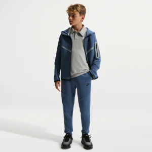 Joggery z akcentami o designie odbijającym światło dla dużych dzieci Nike Tech Fleece - Niebieski