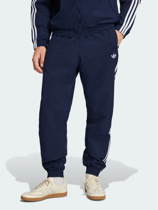 Zdjęcie produktu adidas Spodnie dresowe Firebird Woven KE1370 Granatowy Regular Fit