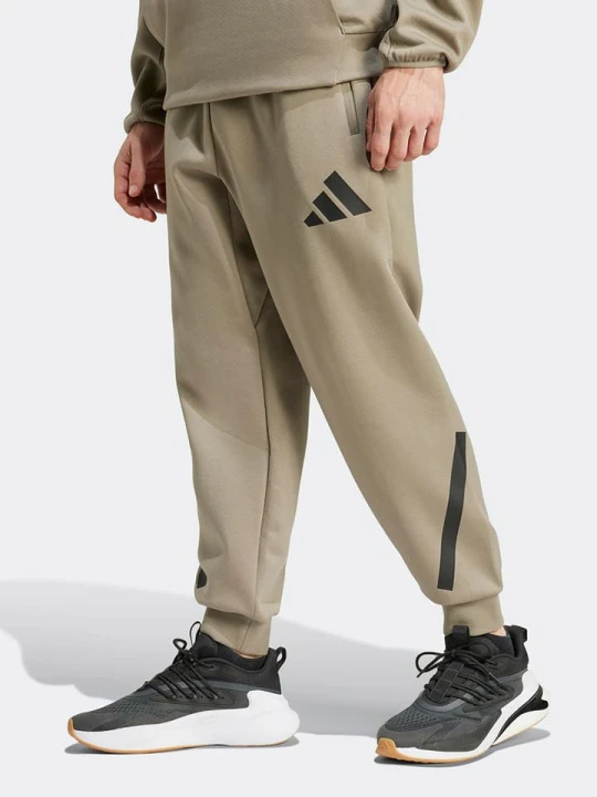 Zdjęcie produktu adidas Spodnie dresowe "M Z.N.E." w kolorze beżowym rozmiar: S