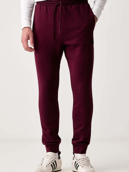 Zdjęcie produktu adidas spodnie dresowe męskie z bawełną Essentials Feelcozy bordowy