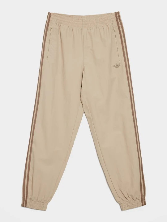 Zdjęcie produktu adidas Spodnie Firebird Woven Track Pants beżowy