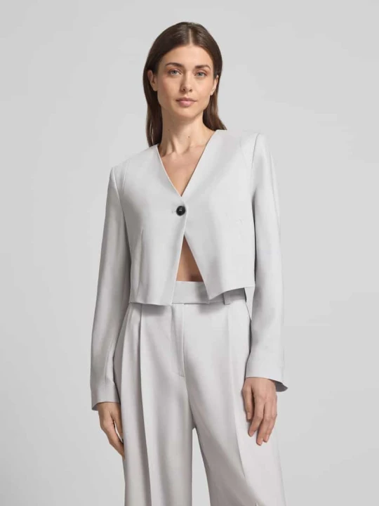 Zdjęcie produktu Asymetrycznie skrojony krótki blezer Style Icon Collection Jasnoszary