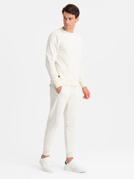 Zdjęcie produktu Bawełniany dresowy komplet męski BASIC bluza nierozpinana + joggery – kremowy V5 Ombre Clothing
