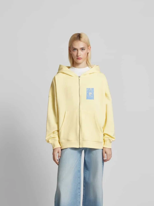 Zdjęcie produktu bluza rozpinana o kroju oversized z nadrukiem z logo Oh April Jasnożółty