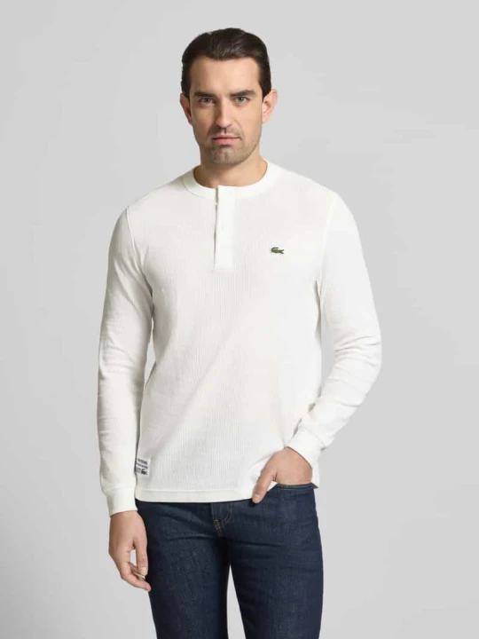 Zdjęcie produktu Koszulka z długim rękawem z mieszanki bawełnianej krój regular fit model 'SERAFINO' Lacoste Złamany biały
