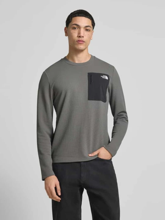 Zdjęcie produktu Bluzka z długim rękawem z kieszenią napoleon model 'KECHA' The North Face Antracytowy
