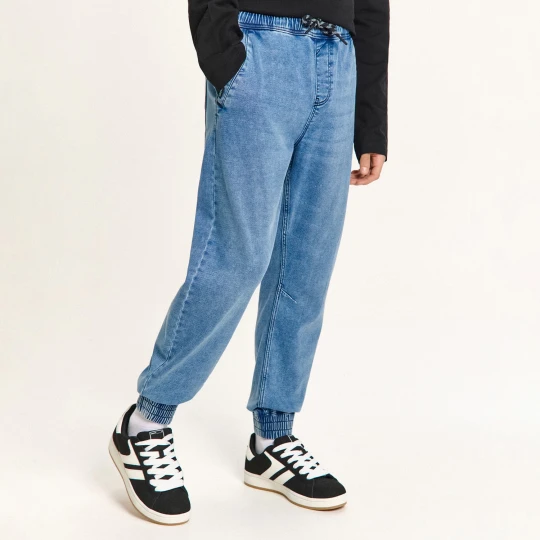 Zdjęcie produktu Cropp - Jeansowe joggery z dekoracyjnymi troczkami - niebieski