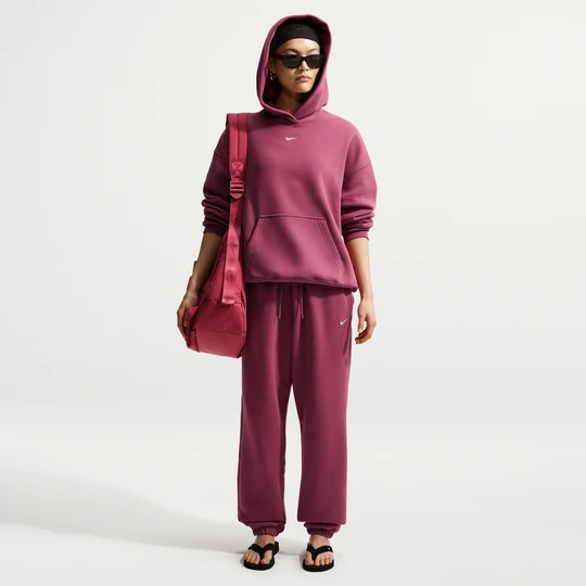 Zdjęcie produktu Damskie oversizowe spodnie z wysokim stanem i ściągaczami Nike Studio Fleece Medium Weight - Czerwony