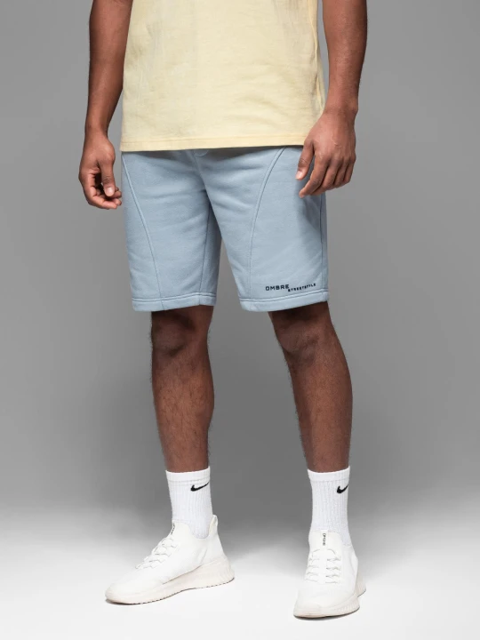 Zdjęcie produktu Dopasowane męskie krótkie spodenki dresowe z nadrukami – jasnoniebieskie V1 - Rozmiar: XL Ombre Clothing