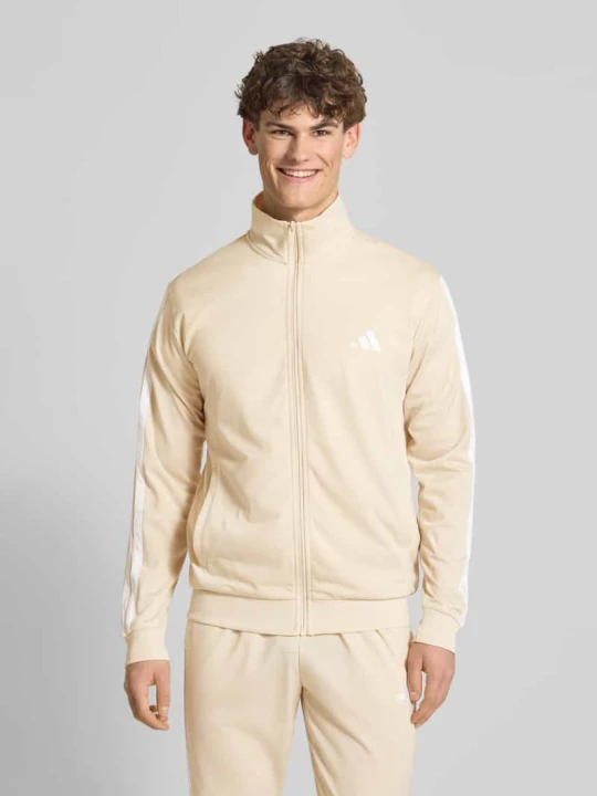 Zdjęcie produktu Garnitur z dzianiny dresowej o kroju regular fit z paskami w kontrastowym kolorze Adidas