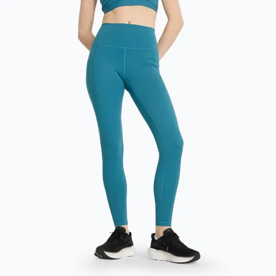 Zdjęcie produktu Legginsy damskie New Balance Sleek Pocket High Rise terrarium Niebieski