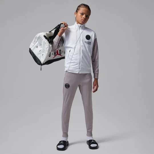Zdjęcie produktu Męski dzianinowy dres piłkarski Jordan Dri-FIT Paris Saint-Germain Strike (edycja nocna) - Biel