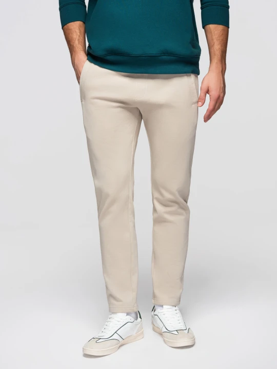 Zdjęcie produktu Męskie bawełniane spodnie dresowe BASIC z nogawką bez ściągacza - jasnobeżowe V1 Ombre Clothing jasny szary