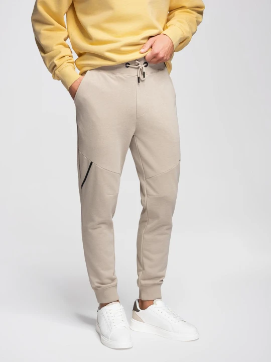 Zdjęcie produktu Męskie spodnie dresowe joggery - beżowe V3 - Rozmiar: M Ombre Clothing