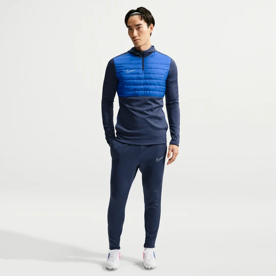 Zdjęcie produktu Męskie spodnie piłkarskie Therma-FIT Nike Academy Winter Warrior - Niebieski