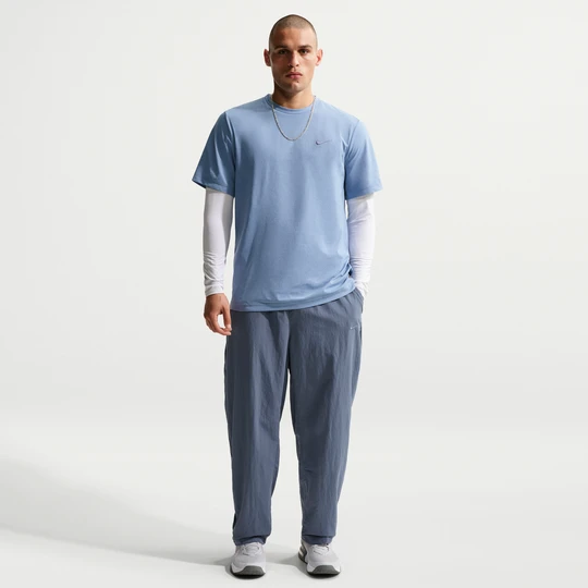 Zdjęcie produktu Męskie spodnie treningowe z tkaniny Dri-FIT Nike N.A.C. - Niebieski
