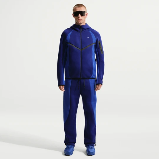 Zdjęcie produktu Męskie spodnie z dzianiny w kontrastowych kolorach z luźnymi nogawkami Nike Tech - Niebieski