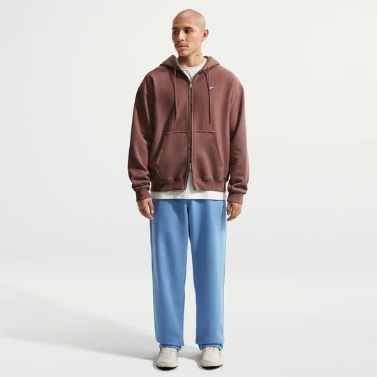 Zdjęcie produktu Męskie spodnie z dzianiny z luźnymi nogawkami Nike Solo Swoosh - Niebieski