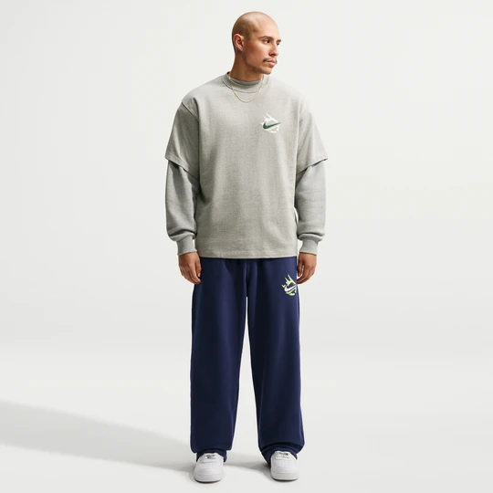 Zdjęcie produktu Męskie spodnie z dzianiny z luźnymi nogawkami Nike Solo Swoosh - Niebieski
