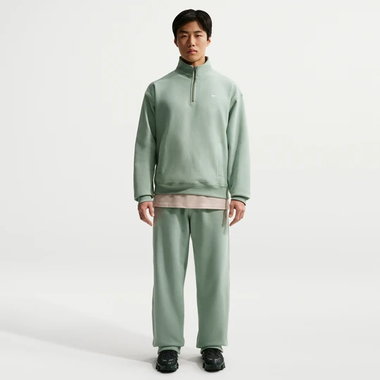 Zdjęcie produktu Męskie spodnie z dzianiny z luźnymi nogawkami Nike Solo Swoosh - Zieleń