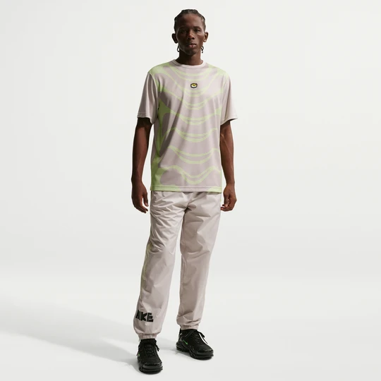 Zdjęcie produktu Męskie spodnie z tkaniny z grafiką Nike Windrunner - Brązowy