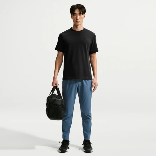 Zdjęcie produktu Męskie uniwersalne spodnie ze ściągaczami i zamkami Dri-FIT Nike Unlimited - Niebieski