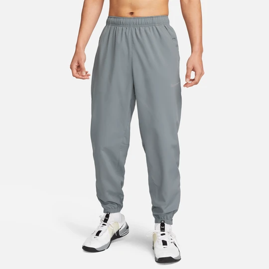 Zdjęcie produktu Męskie uniwersalne spodnie ze zwężanymi nogawkami Dri-FIT Nike Form - Szary