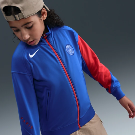 Zdjęcie produktu Przedmeczowa kurtka piłkarska dla dużych dzieci Nike Dri-FIT Total 90 Paris Saint-Germain Academy Pro (wersja trzecia) - Niebieski